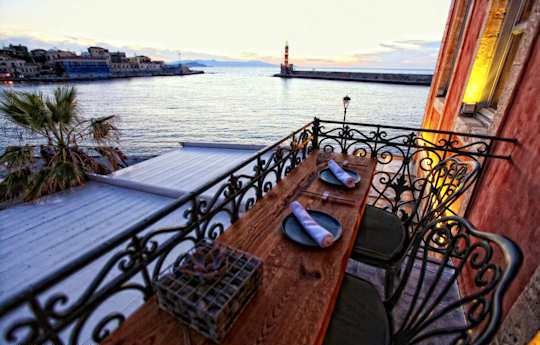 Dine with a view over the Venetian harbour and lighthouse in Chania