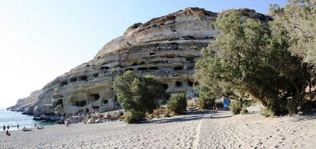 Matala Beach and the ancient burial caves in the sandstone headland, famous for hippie hangouts in the 60's (image by Shadowgate)
