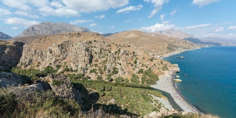 Preveli Beach has a hidden palm forest where the mouth of the gorge meets the sea