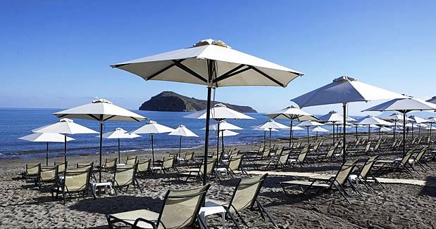 White sand beach with umbrellas and lounges, Chania