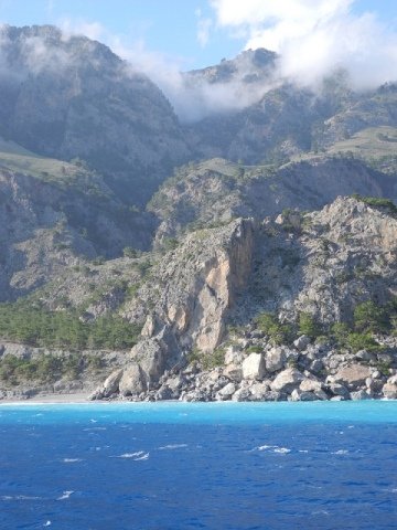 Take a ferry along the south coast of Crete - view the White Mountains falling into the sea