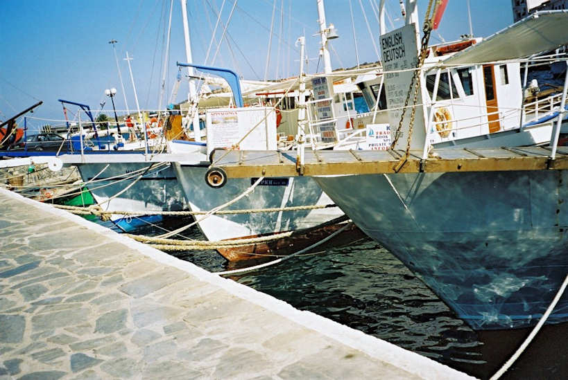 The marine harbour services Mirabello Bay - fishing boats with sunshine reflecting on the hulls