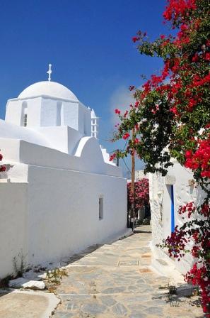 Amorgos Island - a white washed village street scene with pink bougainvillea