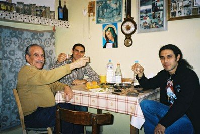 Stin Yiamas! Taso and Toli drink with a friend in a village in Crete
