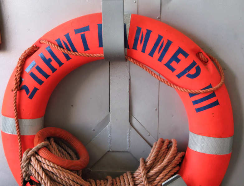 Life Saver with Greek writing on it, ropes stored neatly on the ferry