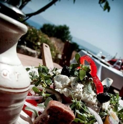 Greek salad and olive oil at a taverna by the sea