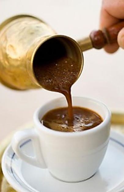 Greek coffee being poured from a briki μπρίκι