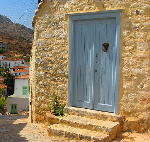 Blue wooden door on stone restored home (Image by Byrdiegirl)