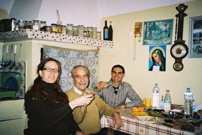 Stin Yiamas! Toli and Katia drink with a friend in a village in Crete
