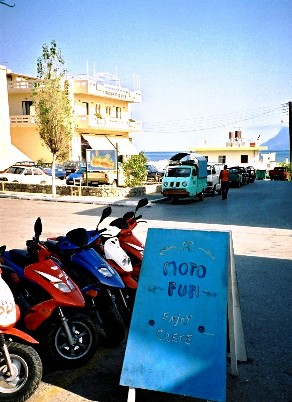 Rent a moto sign with scooters on main street