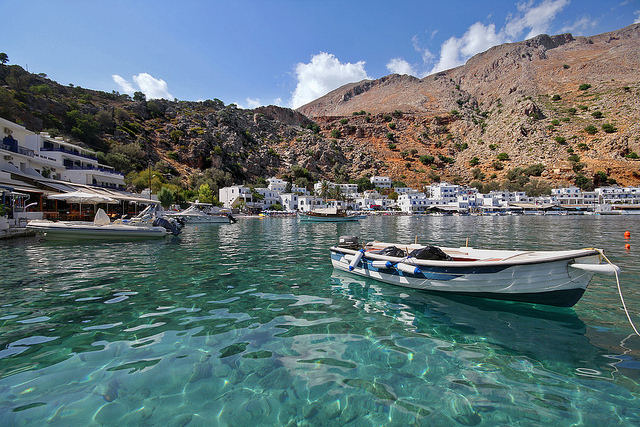 In Loutro, a tiny little white fishing village in the south of Crete, see wooden fishing boats on the clear turquoise waters (image by Miguel Virkkunen Carvalho)