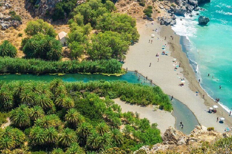 Kourtaliko Gorge meets the sea at a lagoon of palms and a beautiful beach