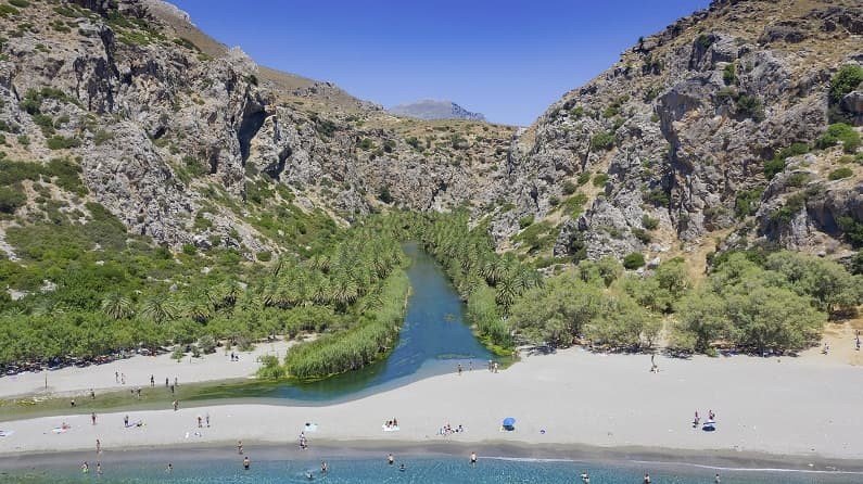 Preveli Beach and lagoon are at the end of Kourtaliko Gorge, across the mountains away from cities, see eagles and vultures as you cross the rugged terrain.