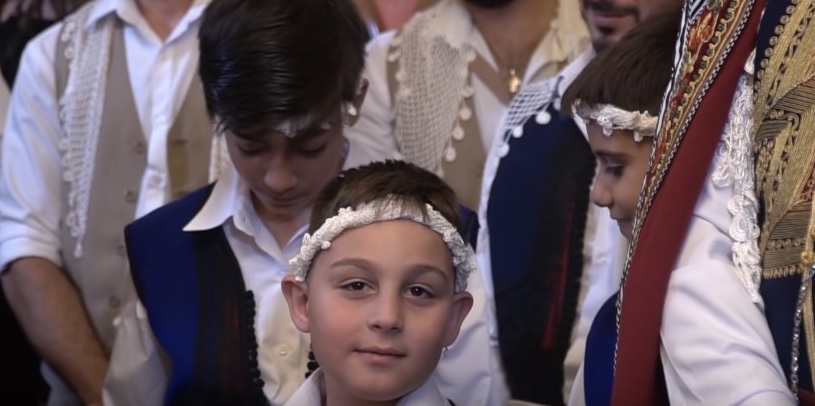 White sarikia being worn by children at a wedding in Crete
